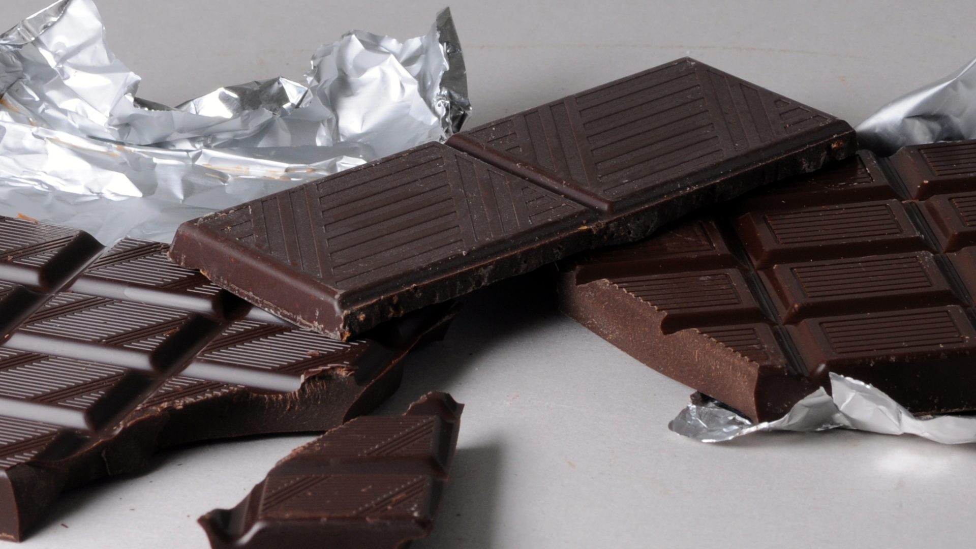 A broken dark chocolate bar showing plain unbranded squares