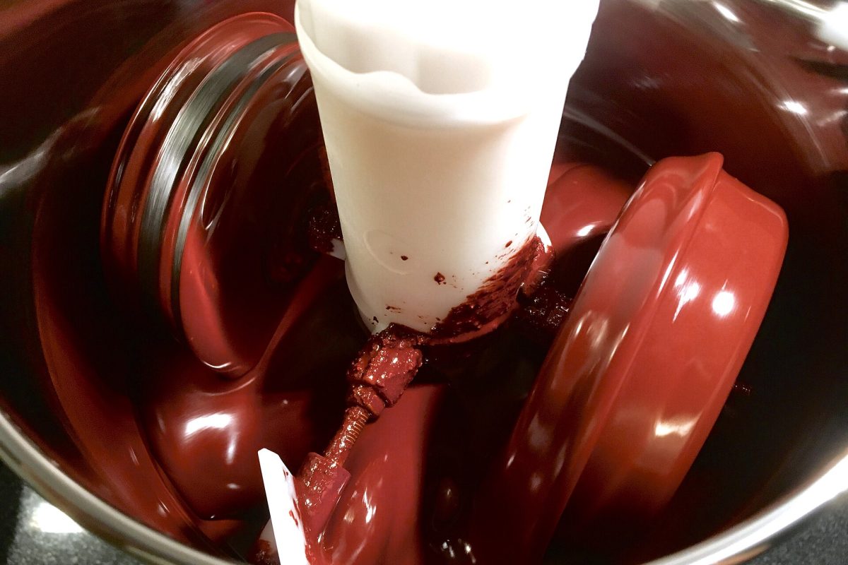 Cocoa liquor being ground in a stone melanger