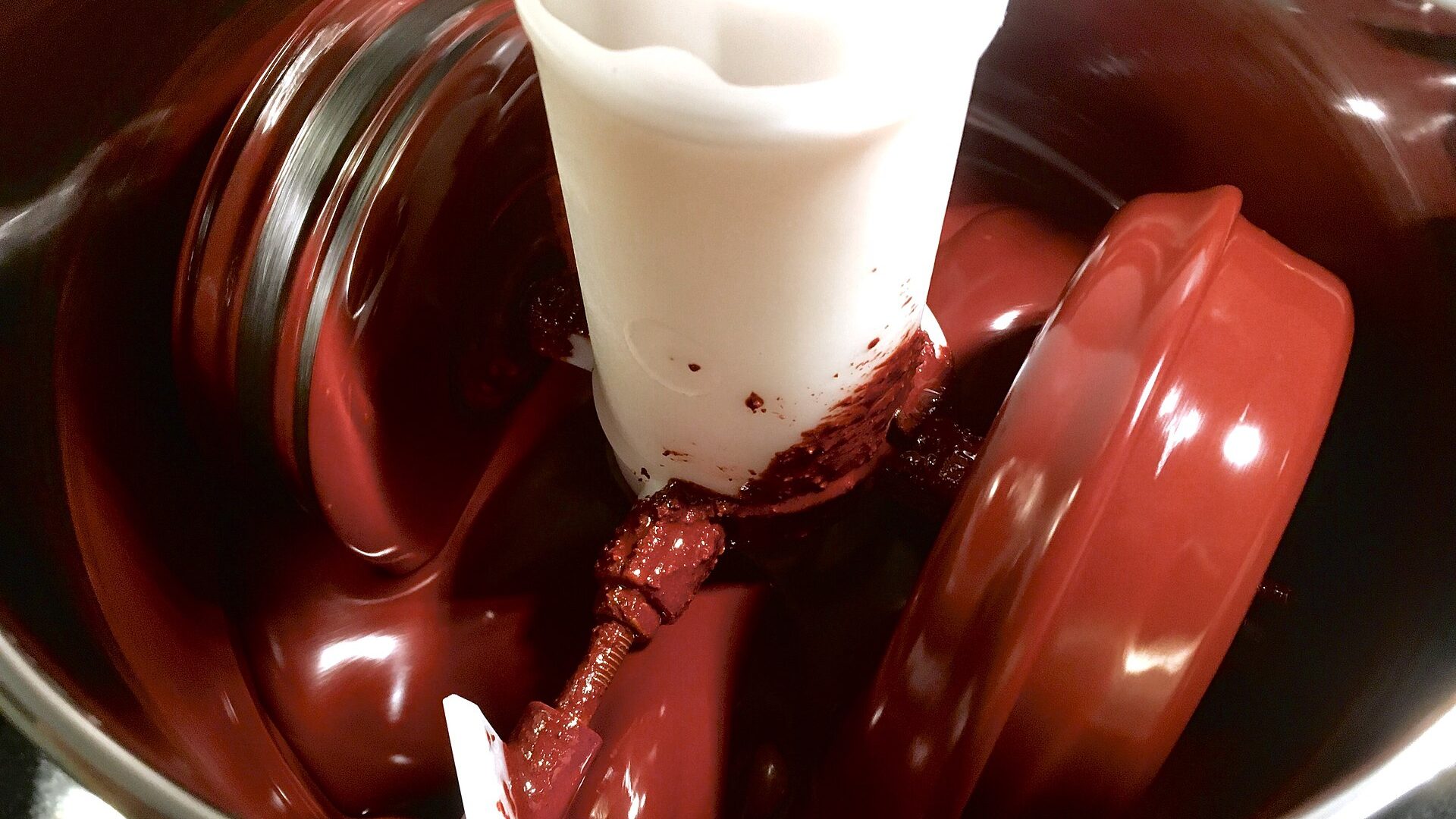 Cocoa liquor being ground in a stone melanger