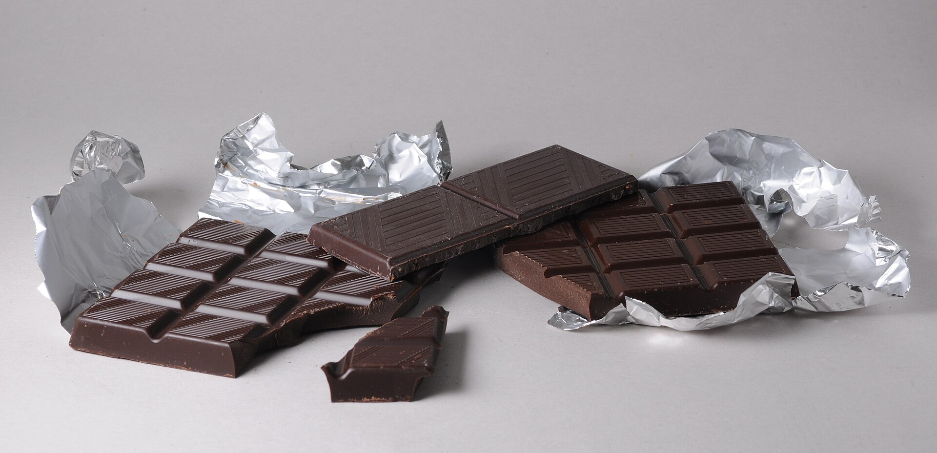 Three foil-wrapped dark chocolate bars