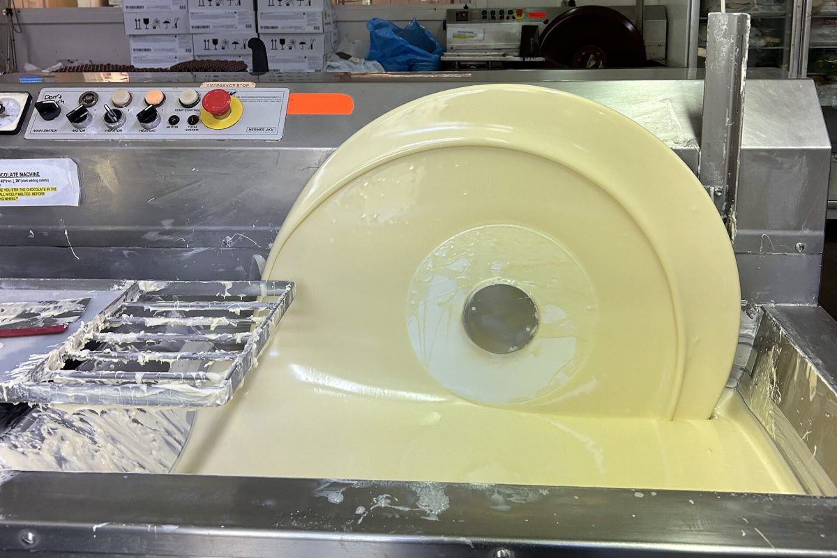 White chocolate being tempered in a mechanical tempering wheel